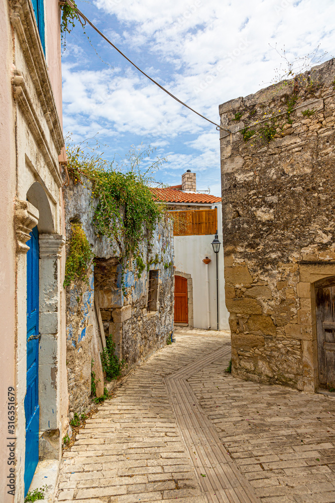 Impression of a street in an very old greek village on the island of crete during daytime