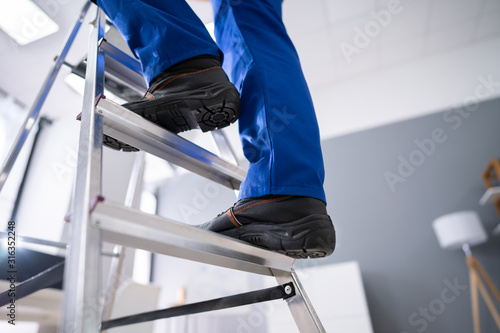 Handyman Climbing Ladder photo