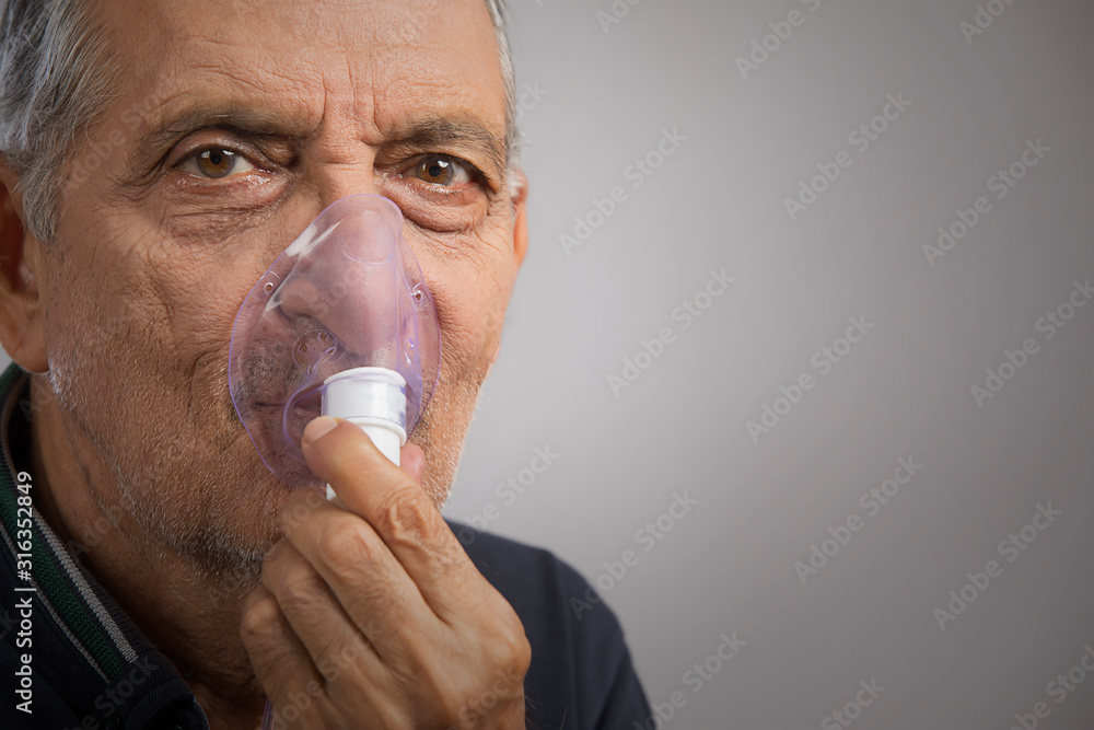 Portrait of a senior man wearing an oxygen mask.(Health and Fitness) Portrait of a senior man wearing an oxygen mask.(Health and Fitness)