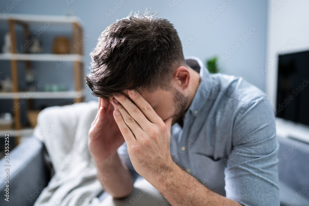 Man Suffering From Headache At Home Man Suffering From Headache At Home
