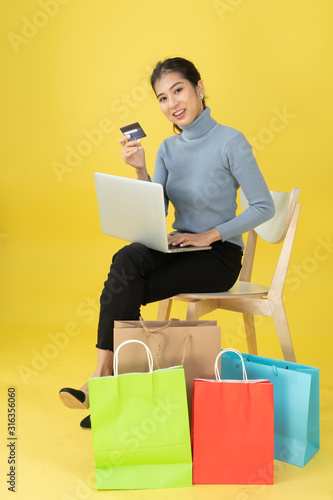 Women holding a credit card to make purchases online. photo