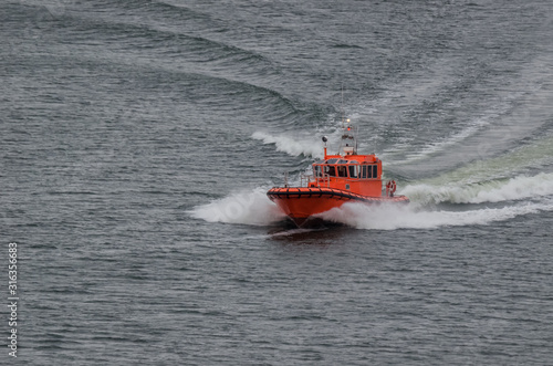 PILOT BOAT - Orange auxiliary boat on the water