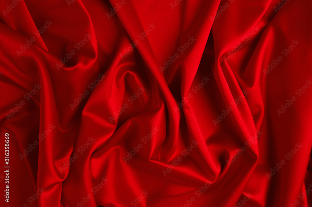 Red silk fabric lying in form of waves. Red silk fabric lying in form of waves.