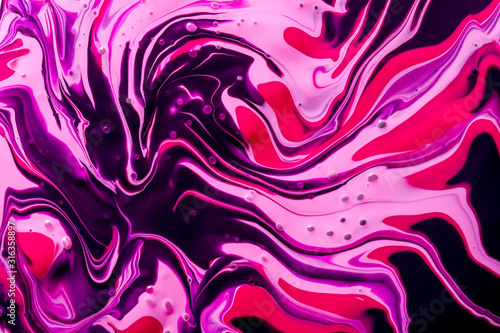 Abstract background of pink, purple and black paint swirls