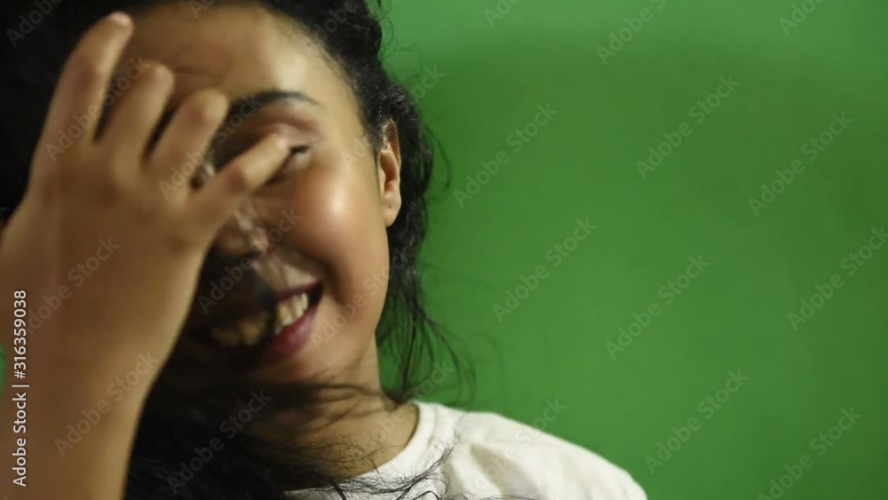 Close-up portrait of a happy beautiful Middle Eastern woman with her black hair looking at the camera and smiling. Close-up portrait of a happy beautiful Middle Eastern woman with her black hair looking at the camera and smiling.