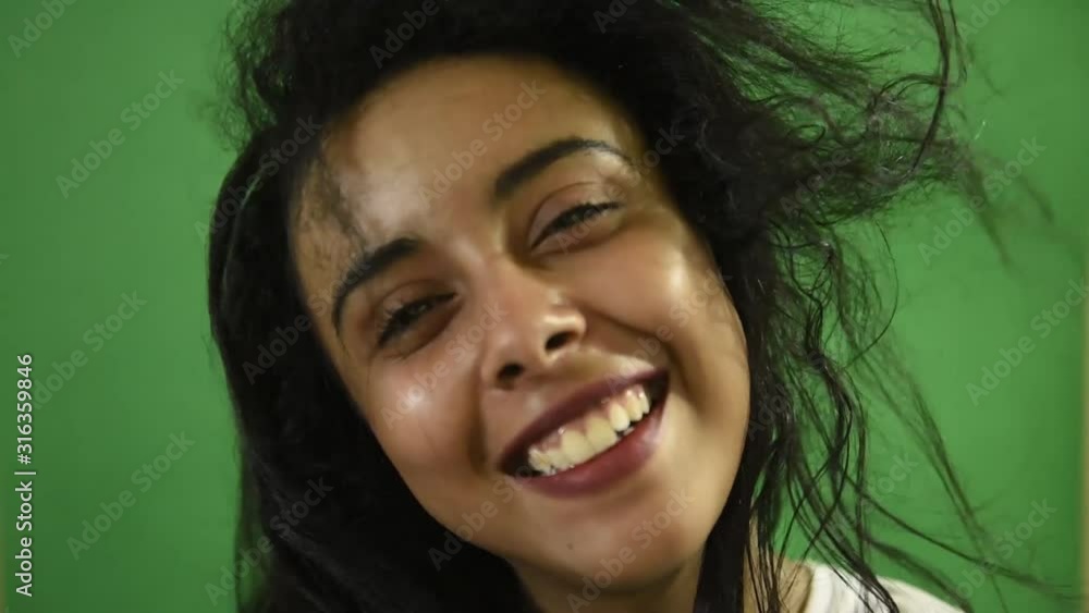 Close-up portrait of a happy beautiful Middle Eastern woman with her black hair looking at the camera and smiling. Close-up portrait of a happy beautiful Middle Eastern woman with her black hair looking at the camera and smiling.