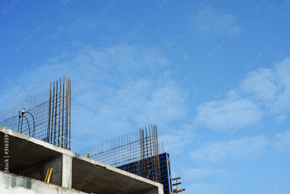 tower cranes against the sky. Yellow construction cranes on a background of blue sky. tower cranes against the sky. Yellow construction cranes on a background of blue sky.