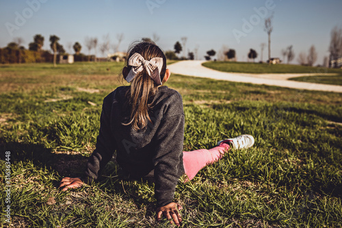 girl sitting on her back relaxing in the open air park, lifestyle concept