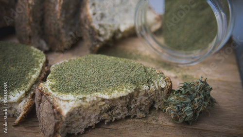 Fotografi Close-up of bread with hemp flour, sandwich with cannabis butter and hashish