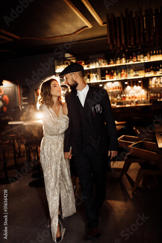 Attractive couple near the bar with beautiful light 