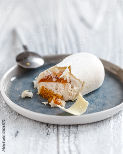 Vegan dessert with orange jelly on a white wooden background
