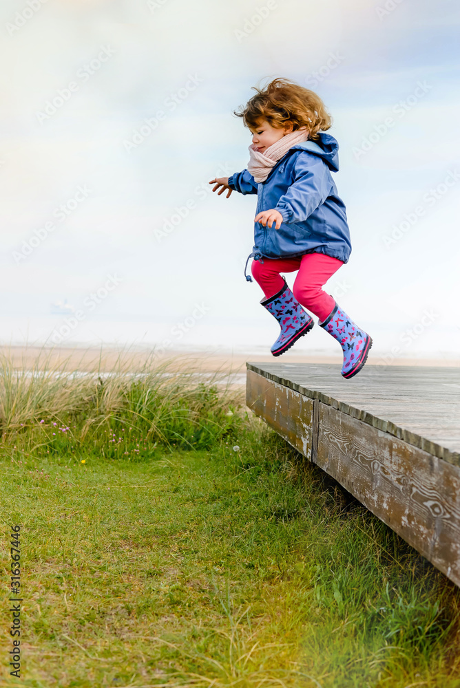 cute little girl jumping in nature cute little girl jumping in nature