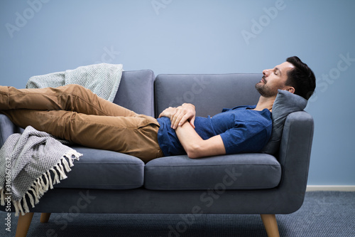 Man Sleeping On Sofa At Home photo