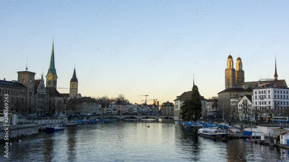 timelapse sunset over zurich city bellevue switzerland with river limmat. downtown zurich orange sunset over grossmünster and frauenkirche timelapse sunset over zurich city bellevue switzerland with river limmat. downtown zurich orange sunset over grossmünster and frauenkirche