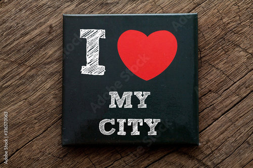 I Love My City written on black note with wood background