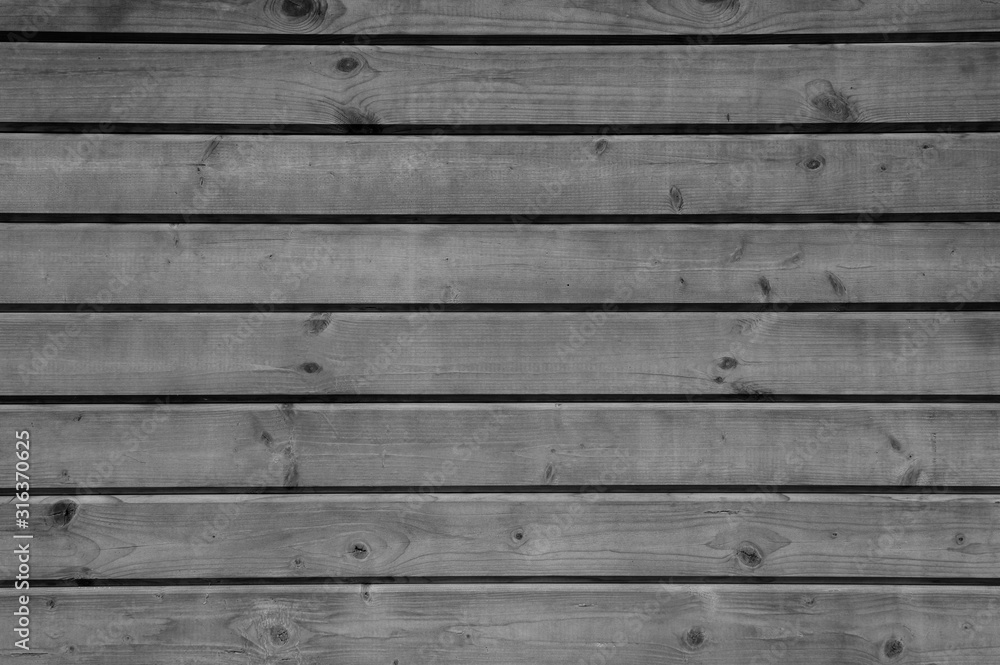 the background is tinted in black and grey colour of old wooden boards the background is tinted in black and grey colour of old wooden boards