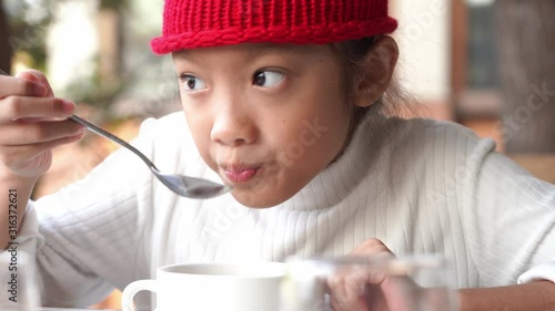 Closeup little asian girl eating cereal with milk,4K