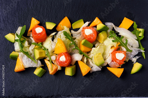 salad with salmon mango avacado and arugula