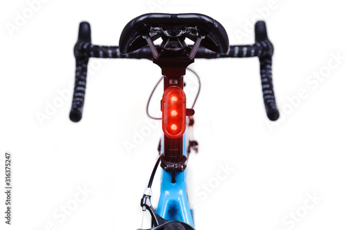 Close-up of bicycle saddle and illuminated tail light
