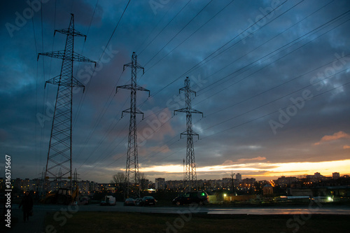 Cityscape with three pylons and rising sun
