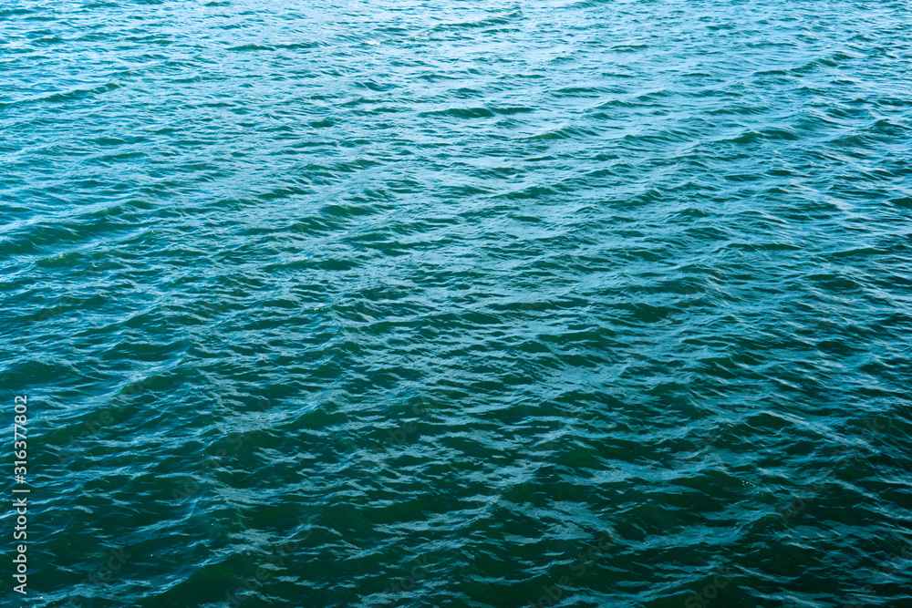 Ocean wave on tropical beach with golden sand and ripple of water splash from emerald blue-green sea water during summer vacation. Ocean wave on tropical beach with golden sand and ripple of water splash from emerald blue-green sea water during summer vacation.