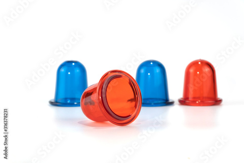 blue and red anti cellulite vacuum silicone banks for body on white background.