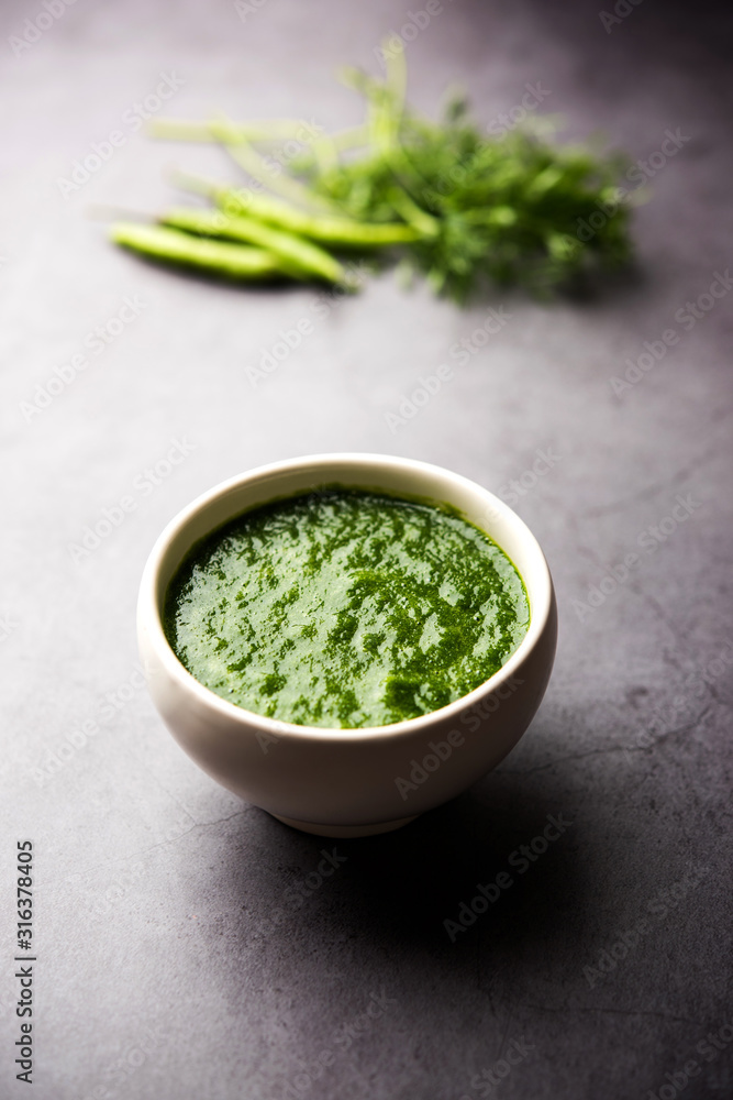 Kothimbir or Dhaniya Chutney made using Cilantro or coriander with chilli, served in a bowl. selective focus Kothimbir or Dhaniya Chutney made using Cilantro or coriander with chilli, served in a bowl. selective focus