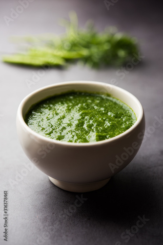 Kothimbir or Dhaniya Chutney made using Cilantro or coriander with chilli, served in a bowl. selective focus