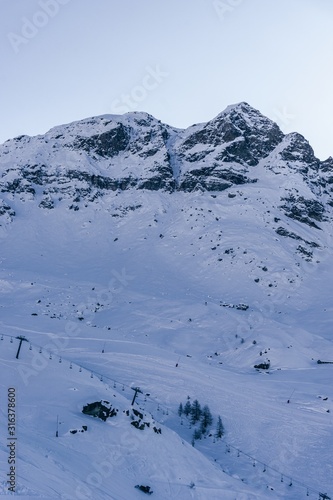 The mountains of the Aosta Valley during the dawn of a winter day near the Matterhorn and the village of Valtournenche, Italy - December 2019. photo