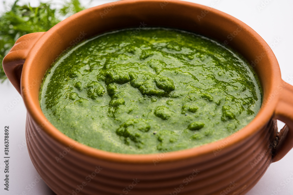 Kothimbir or Dhaniya Chutney made using Cilantro or coriander with chilli, served in a bowl. selective focus Kothimbir or Dhaniya Chutney made using Cilantro or coriander with chilli, served in a bowl. selective focus