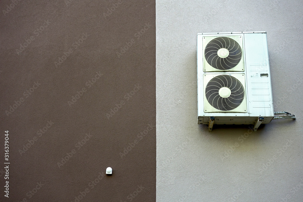 Air conditioner attached to the insulated wall of the building Air conditioner attached to the insulated wall of the building