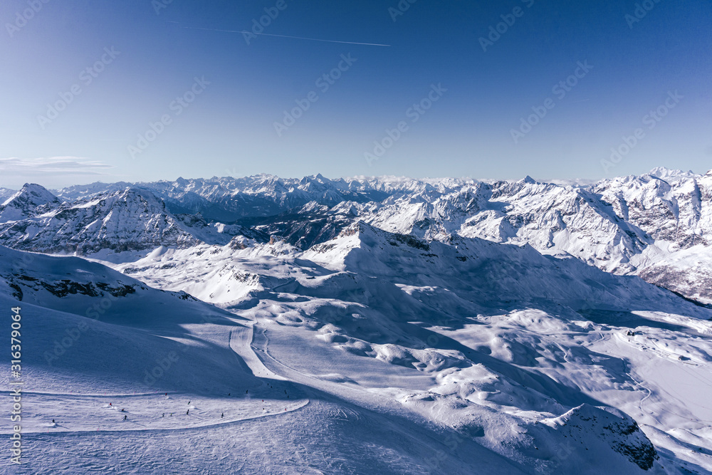 The mountains of the Aosta Valley during a fantastic winter day near the Matterhorn and the town of Breuil-Cervinia, Italy - December 2019.