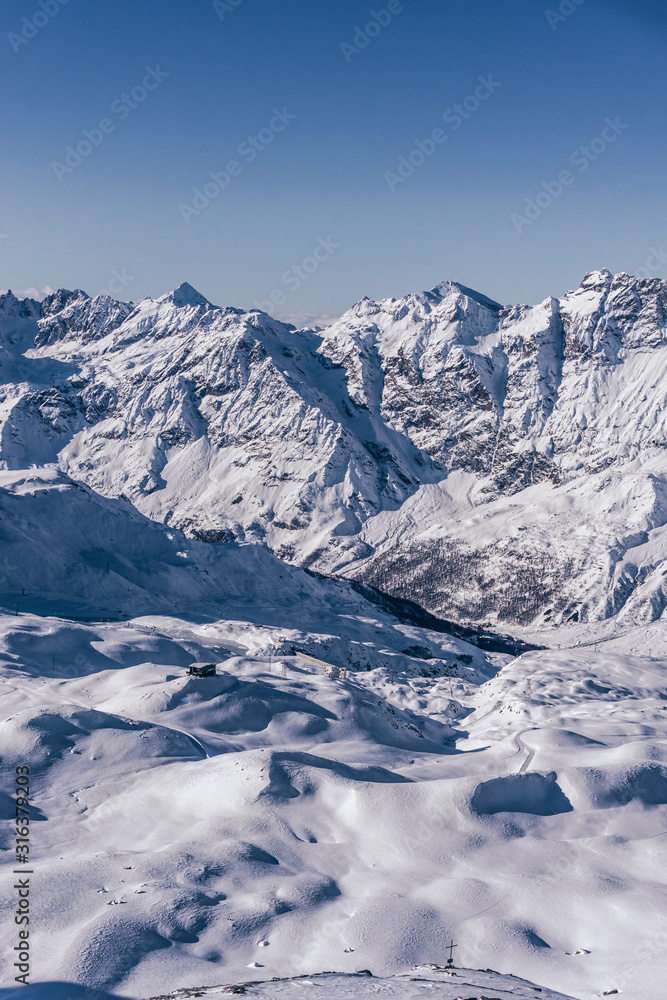 The mountains of the Aosta Valley during a fantastic winter day near the Matterhorn and the town of Breuil-Cervinia, Italy - December 2019.