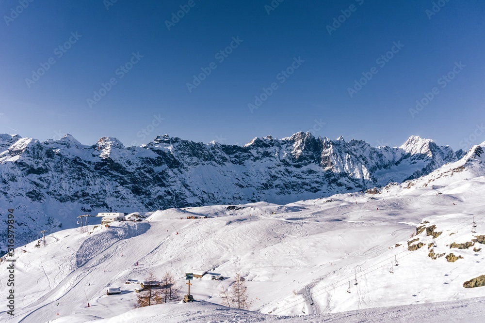 The mountains of the Aosta Valley during a fantastic winter day near the Matterhorn and the town of Breuil-Cervinia, Italy - December 2019.