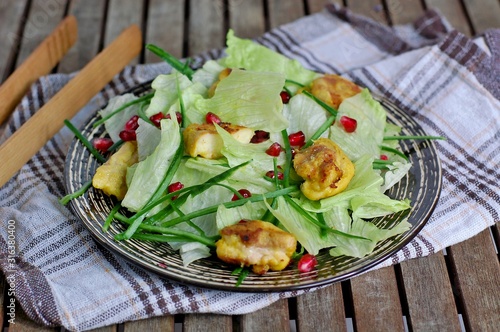 Fresh salad with lettuce, cucumber,pomegranate and chicken fillet