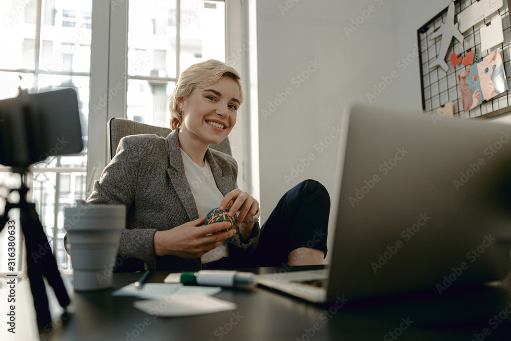 Happy beautiful woman is sitting at workplace Happy beautiful woman is sitting at workplace