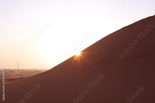 Sunrise in the red desert sand dunes of the Arabian Desert in Riyadh, Saudi Arabia