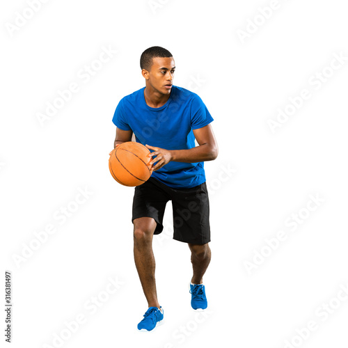Full-length shot of Afro American basketball player man over isolated white background © luismolinero