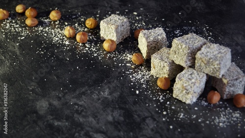 turkish delight with hazelnuts on a black background
