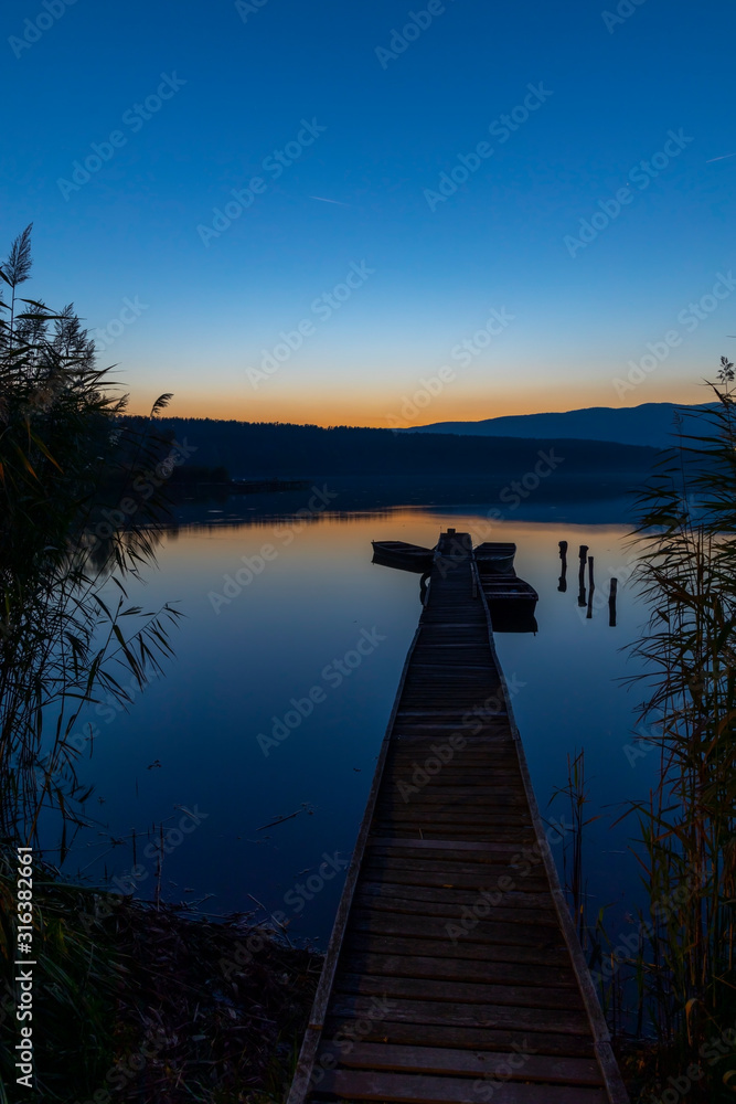 Fototapeta premium fishing boat at pier on Jenoi pond near Diosjeno, Northern Hungary