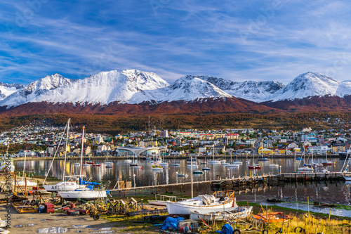 Colorful scene view of the bay and Ushuaia city against Andes mountains during autumn sean
