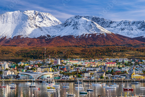 Colorful scene view of the bay and Ushuaia city against snow-capped Andes mountains during autumn season, Tierra del Fuego, Patagonia, Argentina photo
