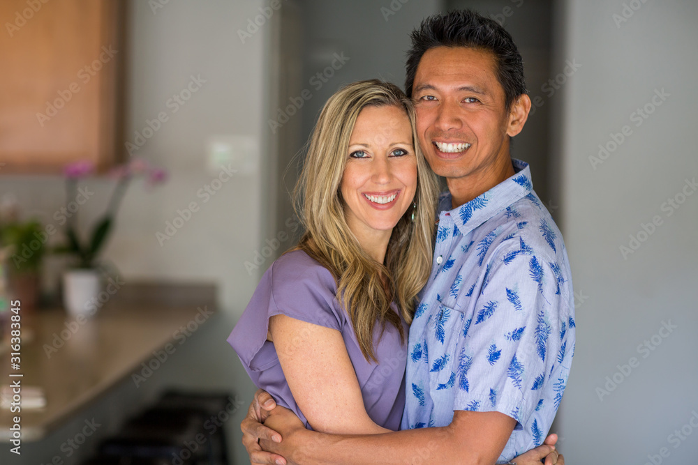 Portrait of a mixed race couple smiling and hugging. Portrait of a mixed race couple smiling and hugging.
