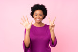 African american woman over isolated pink background counting seven with fingers