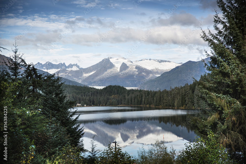 Reflection of a mountain scene on lake in Alaska