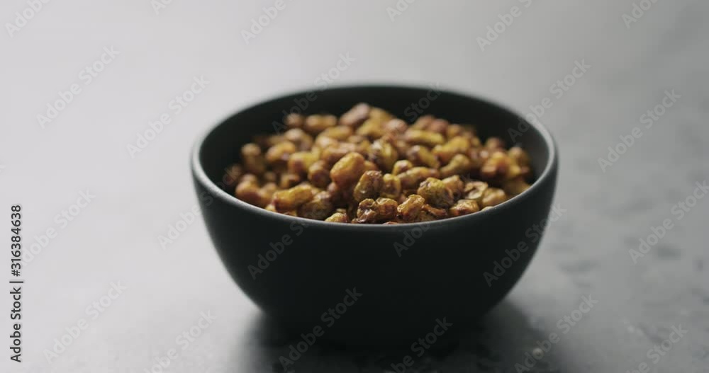 Slow motion handheld shot of dried seaberry in black bowl on terrazzo countertop Slow motion handheld shot of dried seaberry in black bowl on terrazzo countertop