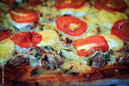 Pizza cooked in the oven. Pizza with minced meat, cheese, tomatoes