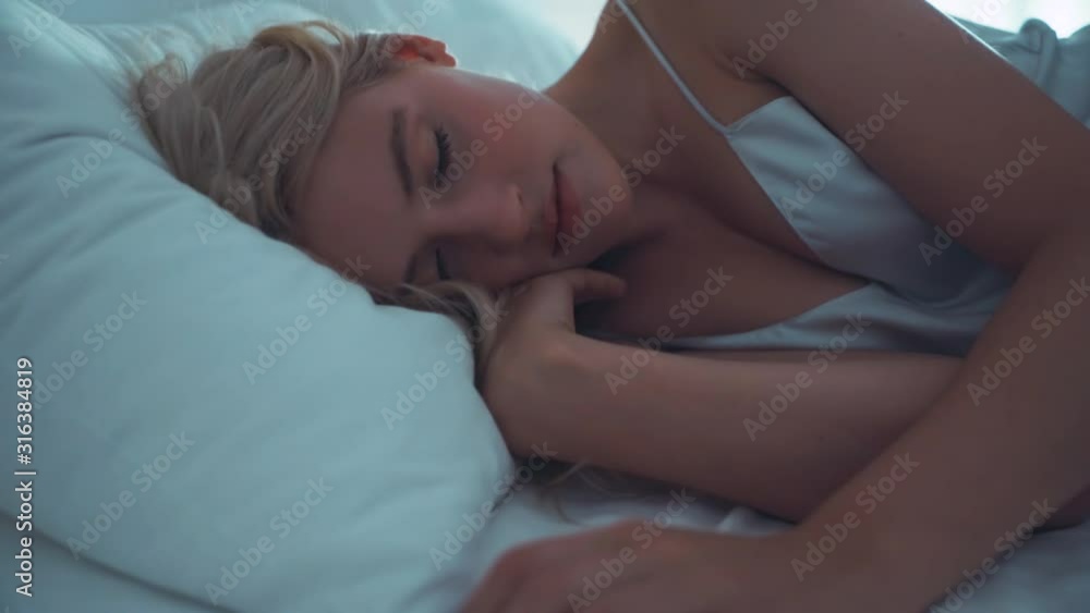 Close up view of face beautiful woman sleeps on the bed in underwear lying resting with eyes closed beauty young bedroom lifestyle female room sleeping slow motion Close up view of face beautiful woman sleeps on the bed in underwear lying resting with eyes closed beauty young bedroom lifestyle female room sleeping slow motion
