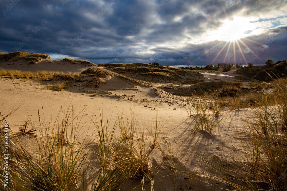 Dunes in the Slowinski National Park. Landscape with beautiful sky, clouds and dunes in the sun. Czolpino, Leba, Poland.