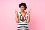 African american woman over isolated pink background with fingers crossing and wishing the best